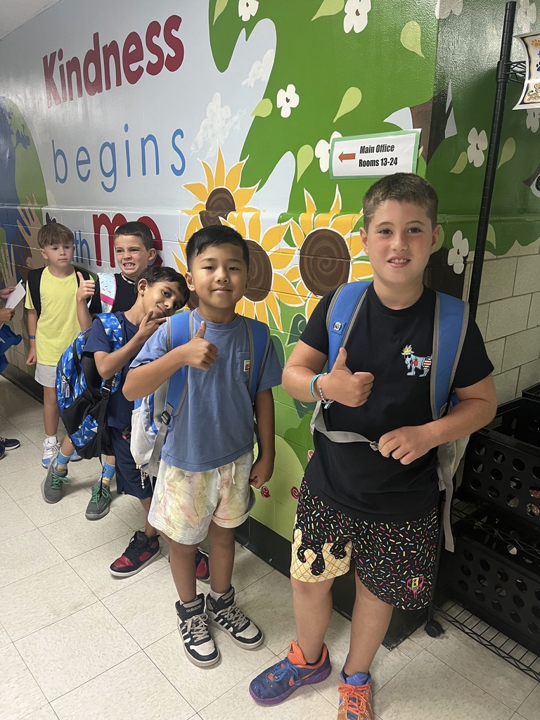 3rd graders give a thumbs up.