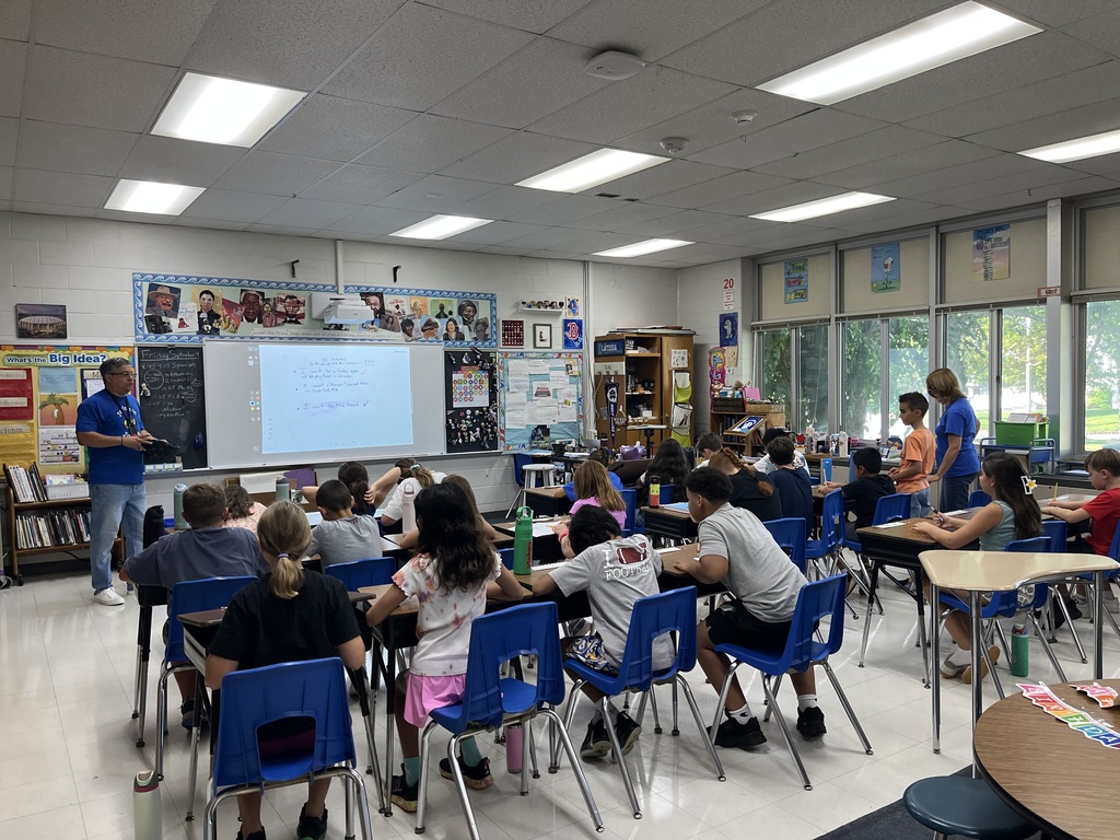 Teacher plays a group game with the class. 