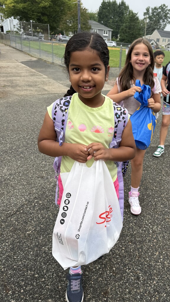 two girls standing at the front of a line during arrival on the first day of school
