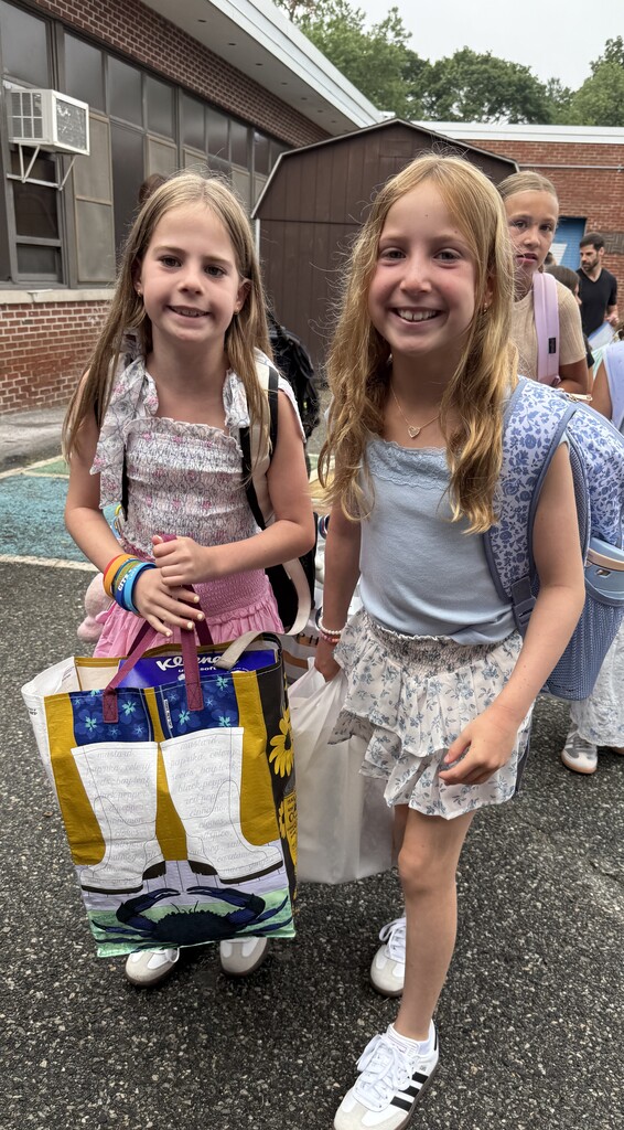 two girls standing during arrival on the first day of school