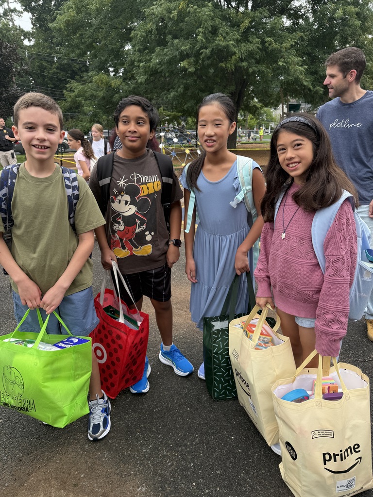 four students standing during arrival on the first day of school