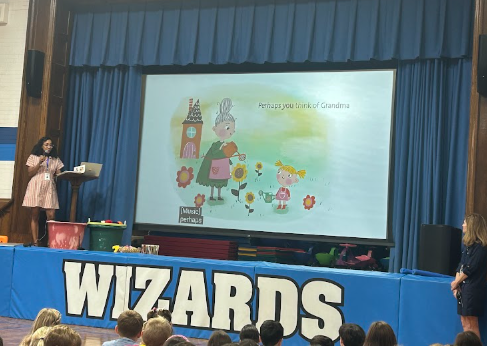 principal reading to the school