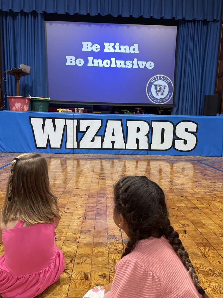 students looking at slide saying be kind, be inclusive