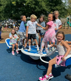 students playing on new playground rocker