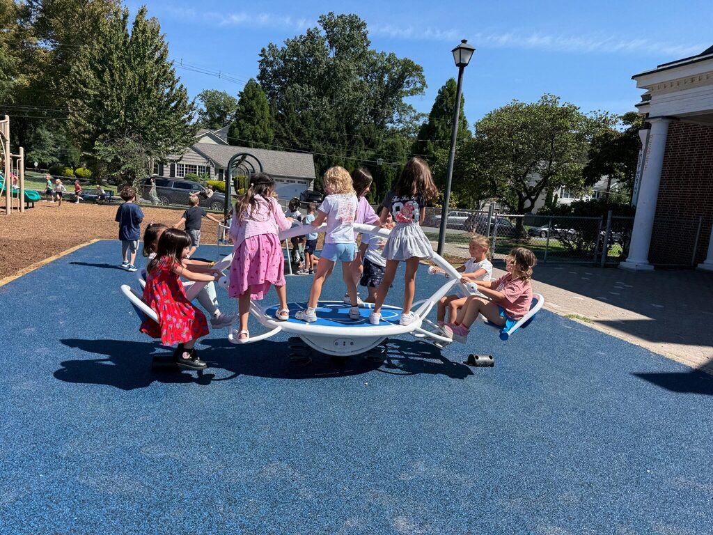 students playing on new playground rocker