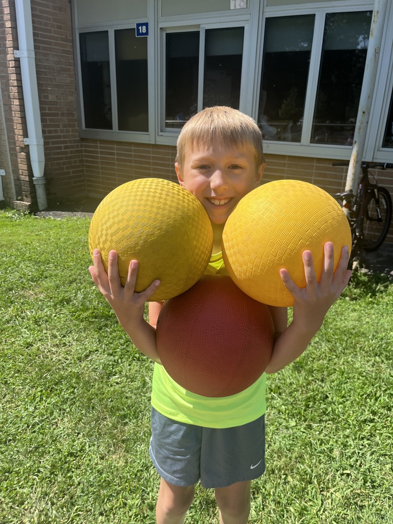 Student carries 3 balls - deciding on which is the bounciest.