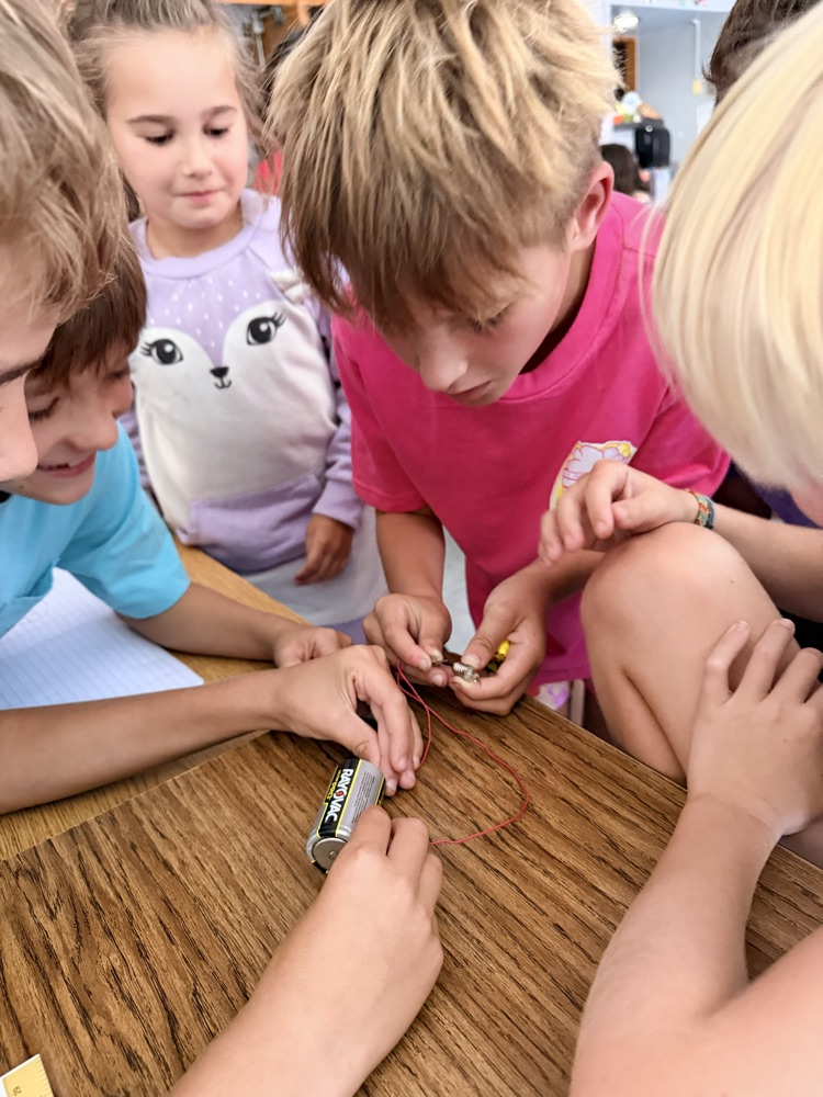 students engage in a science experiment about energy