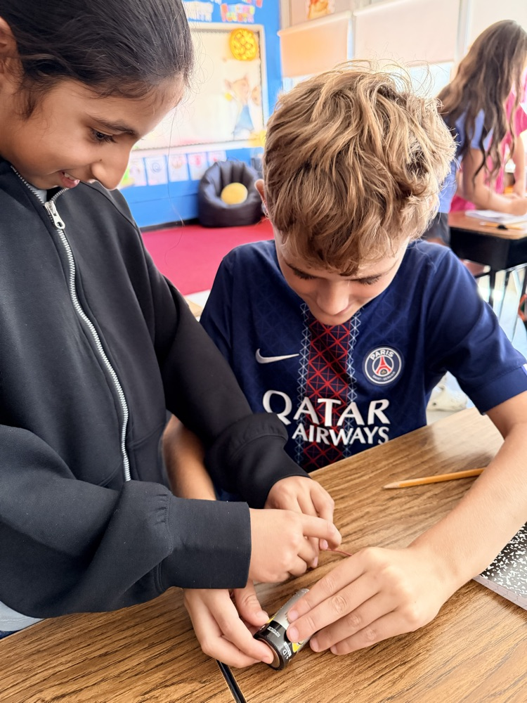 students engage in a science experiment about energy