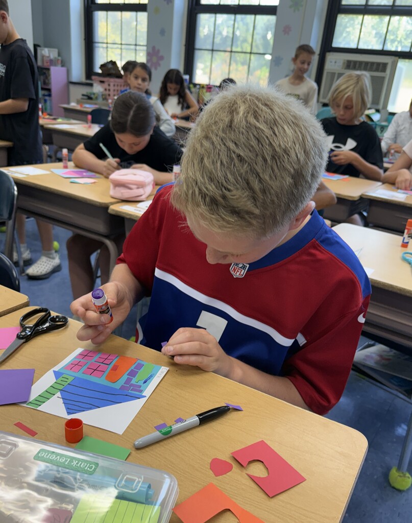 student working on their unique collage house