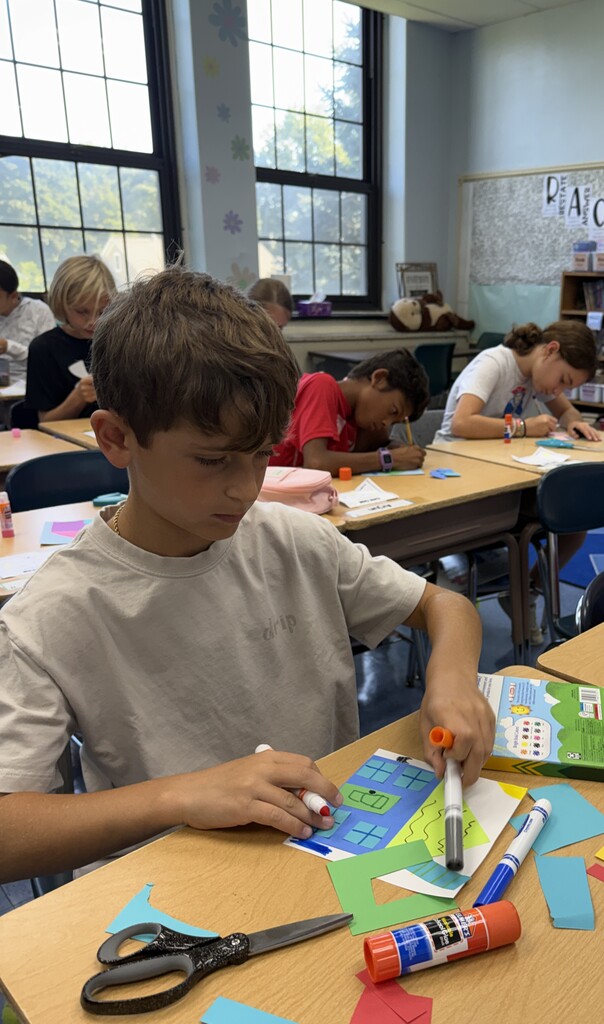 student working on their unique collage house