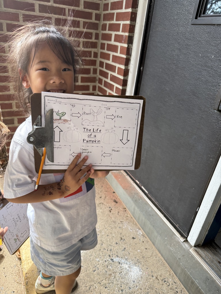 student holding clipboard with observations paper