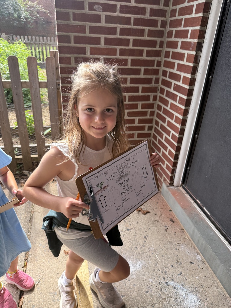 student holding clipboard with observations paper
