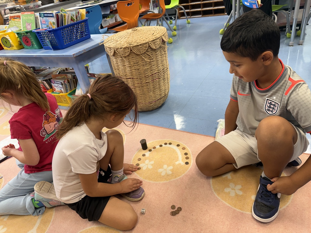 students playing penny dice game on the rug