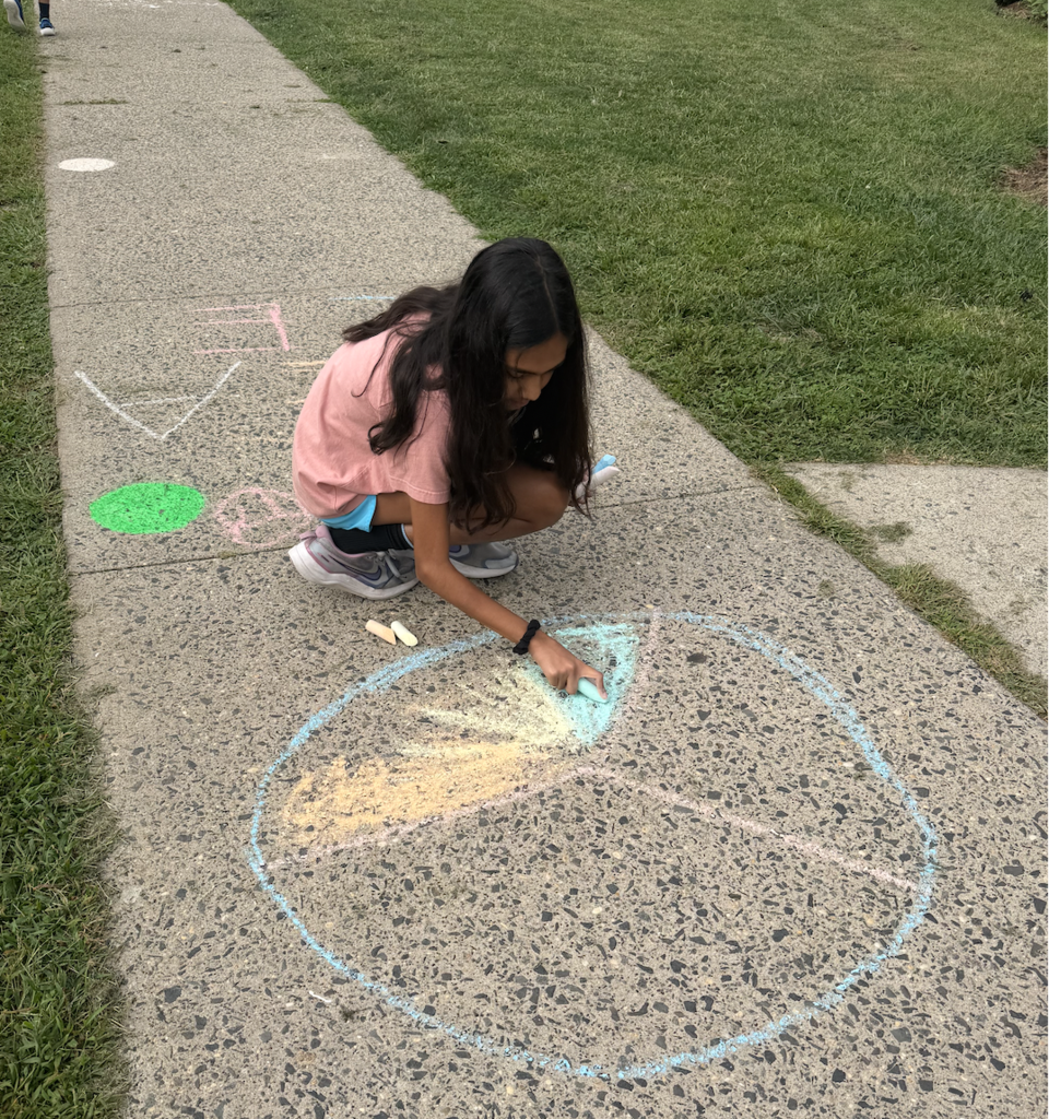 Student coloring in the peace sign