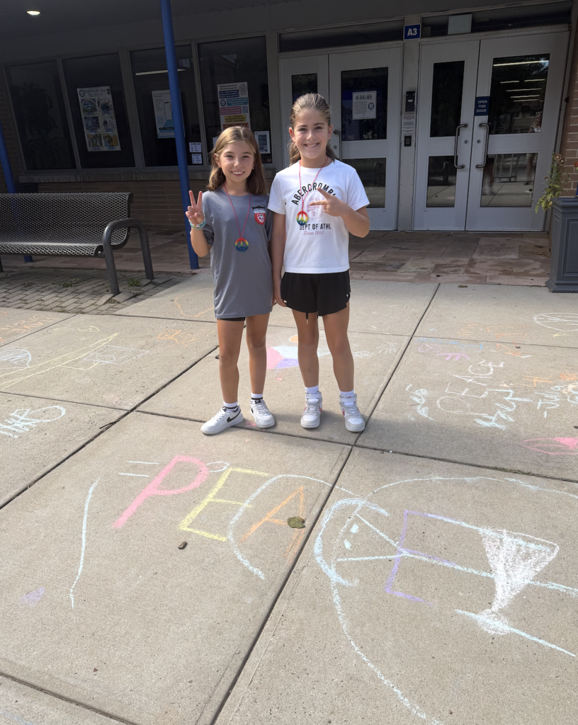 Students showing the peace sign