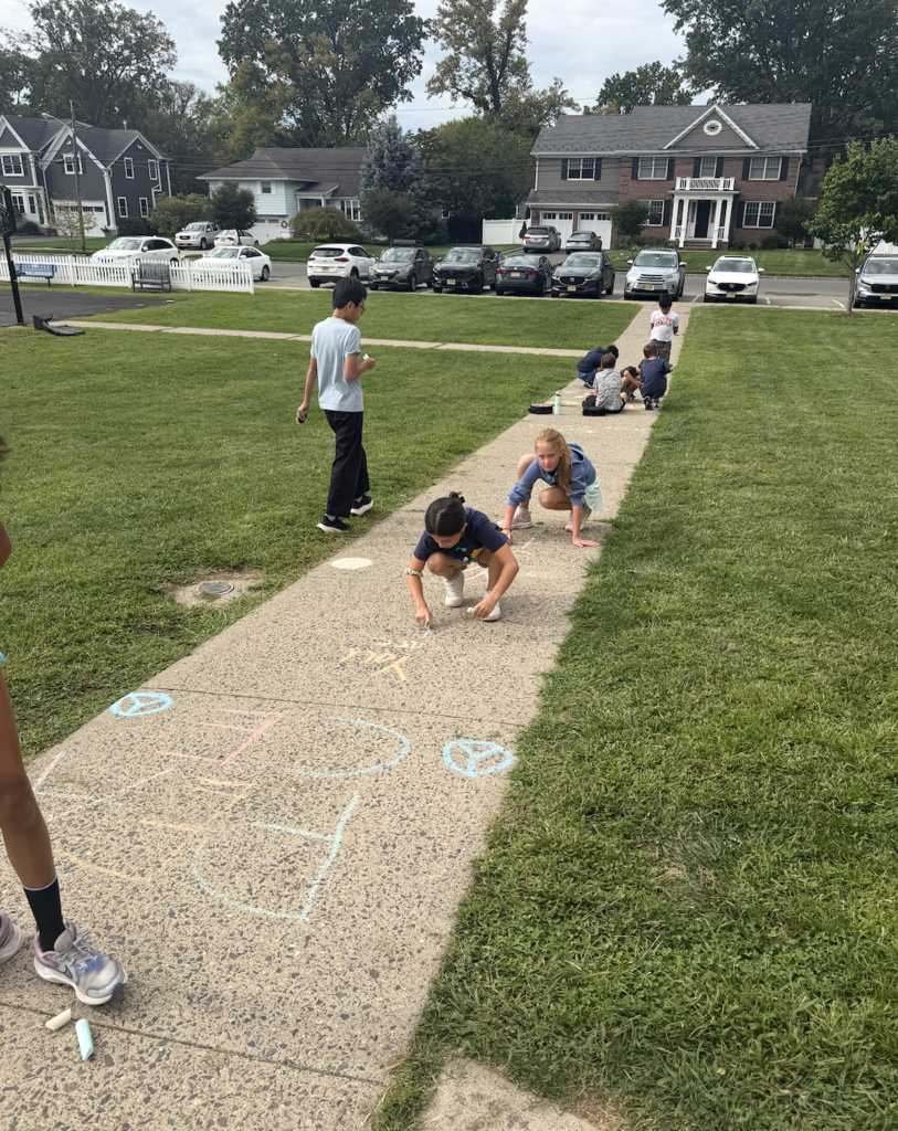 Students drawing peace signs