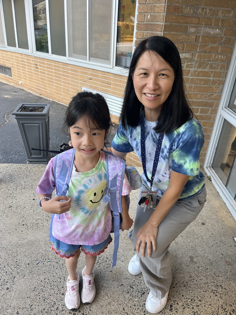 Principal and student wearing tie dye shirts to show peace.