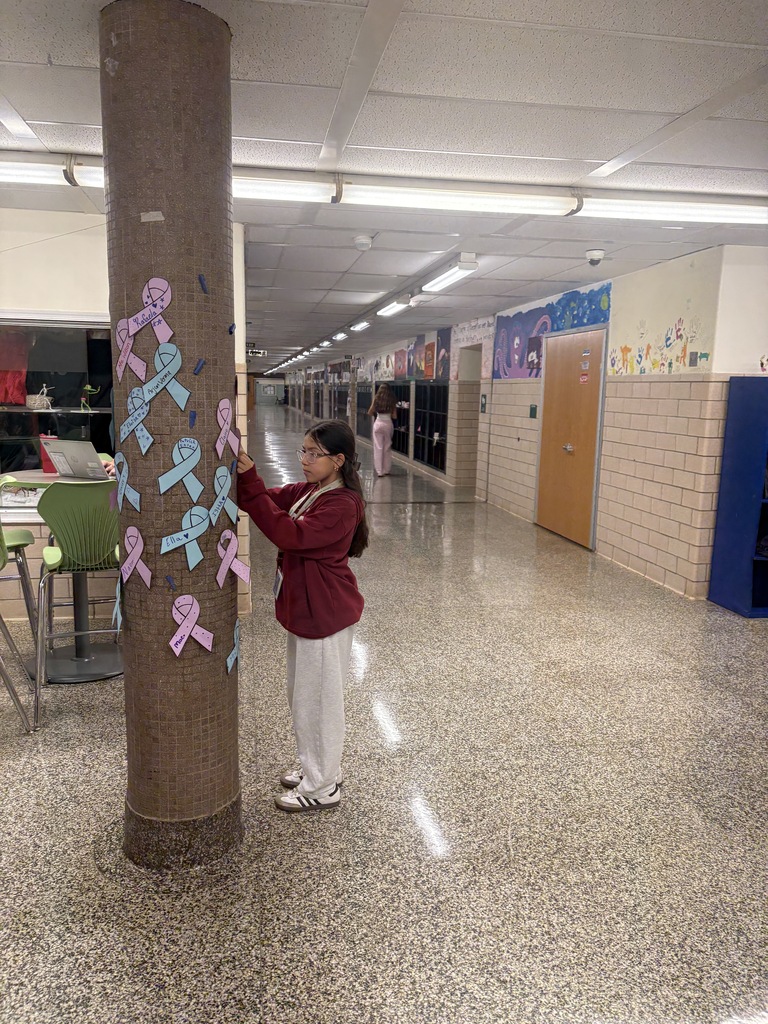 Student hanging up ribbon