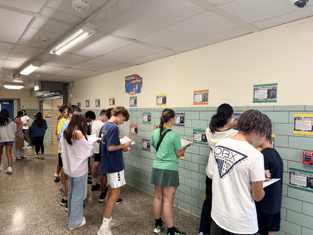 students looking at wall displays