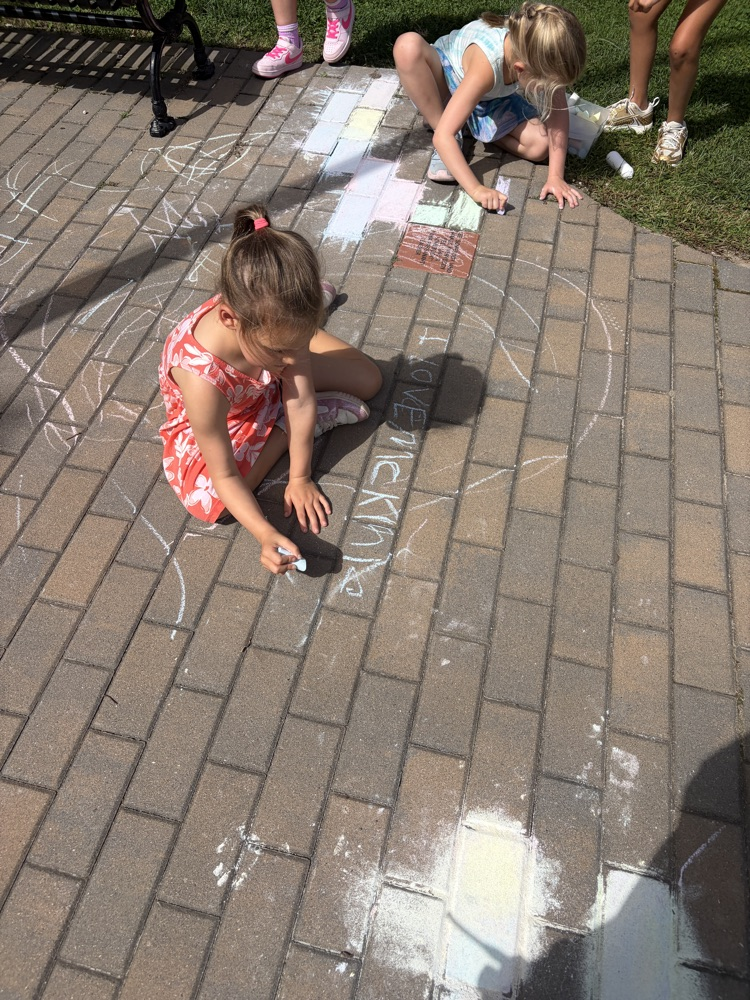 student drawing with chalk