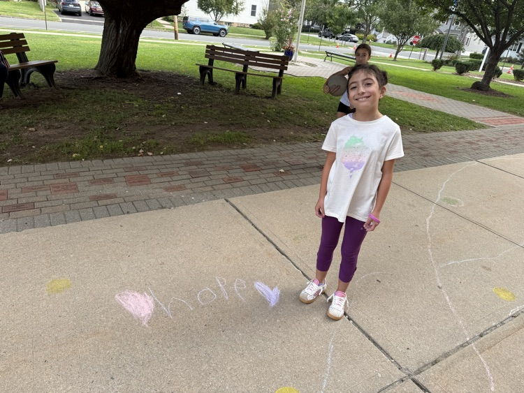 student drawing with chalk