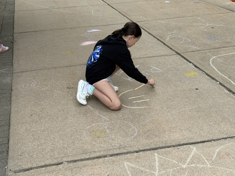 student drawing with chalk