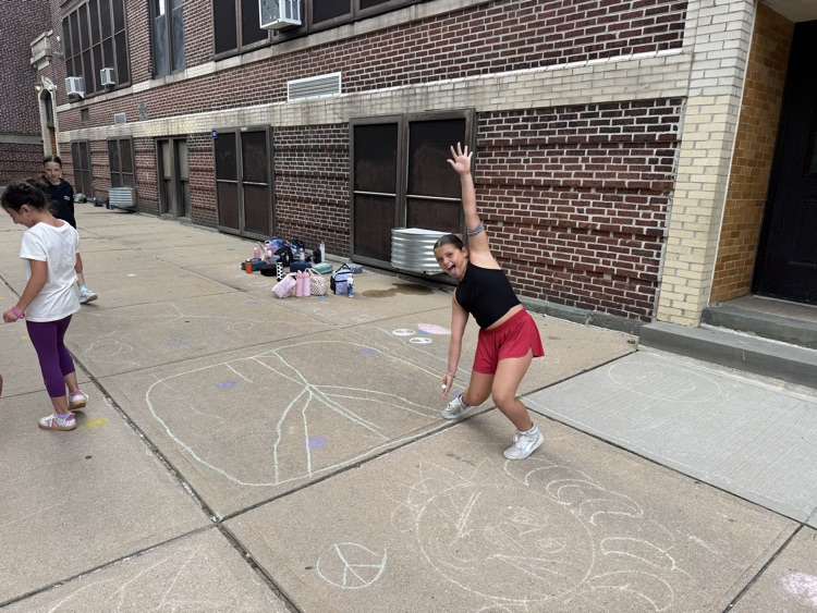 student drawing with chalk