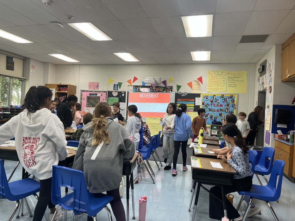 Students excited to enter a new classroom.