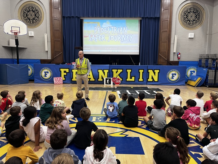 pedestrian safety assembly. students practicing using a crosswalk 