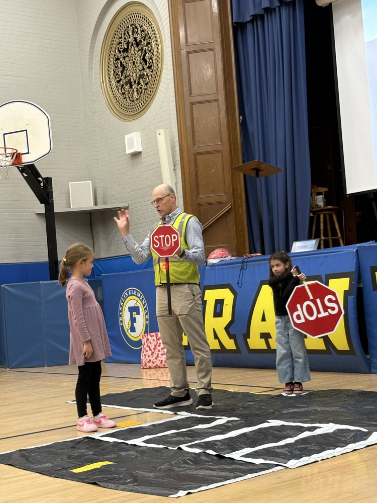 pedestrian safety assembly. students practicing using a crosswalk 