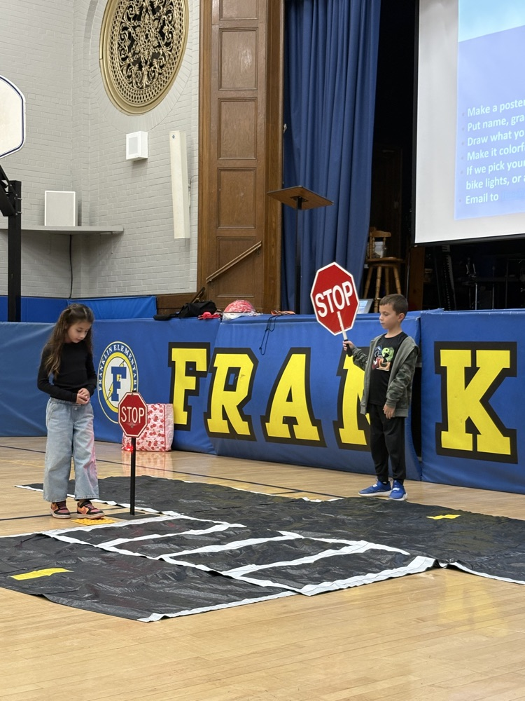 pedestrian safety assembly. students practicing using a crosswalk 