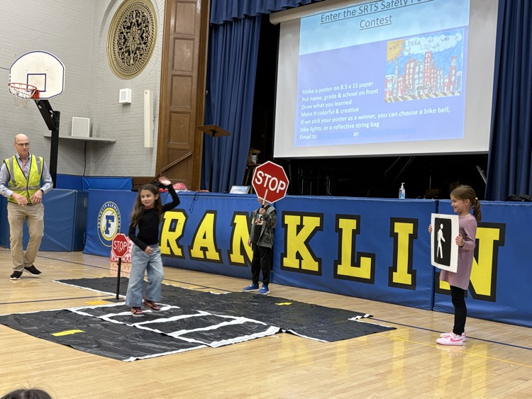 pedestrian safety assembly. students practicing using a crosswalk 
