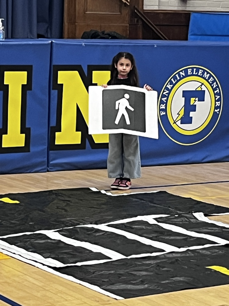 pedestrian safety assembly. students practicing using a crosswalk 