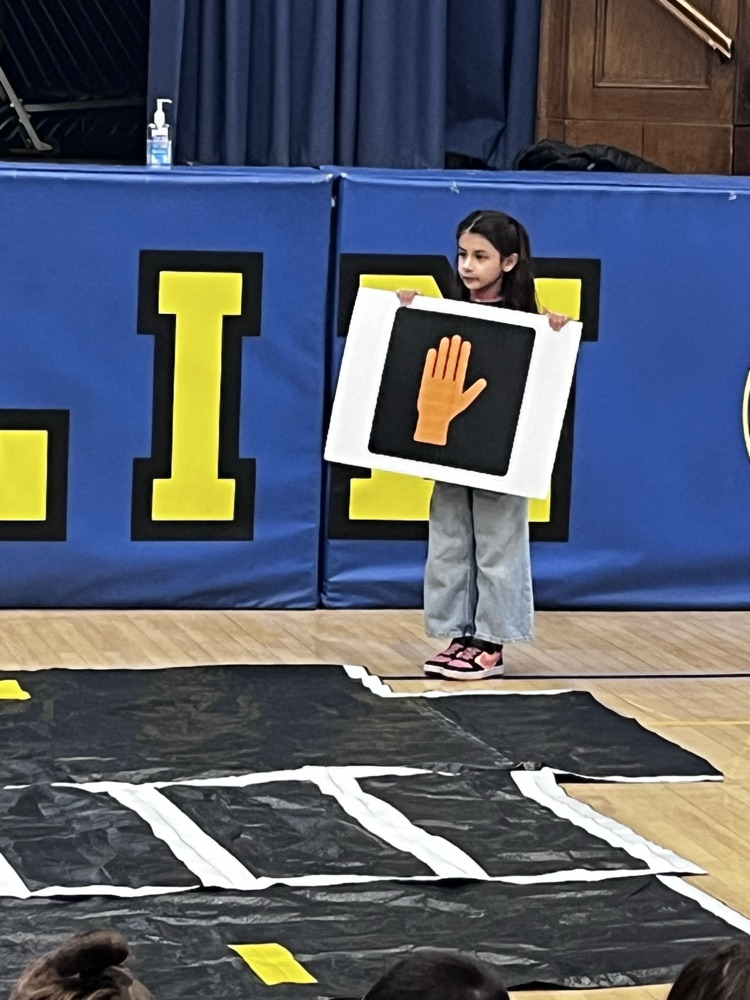 pedestrian safety assembly. students practicing using a crosswalk 