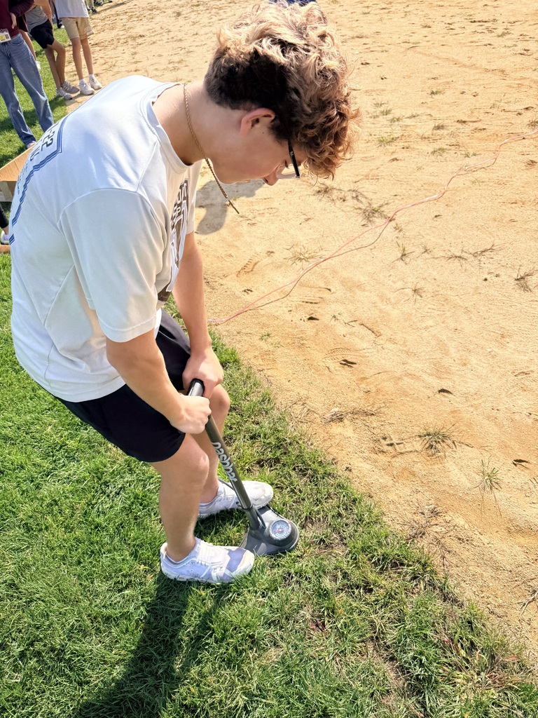 student pushing down on air pump