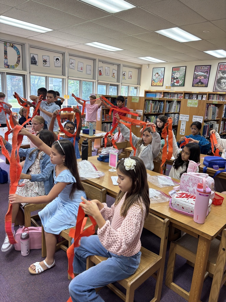 Students trying to figure out how to wear their new safety belts. 