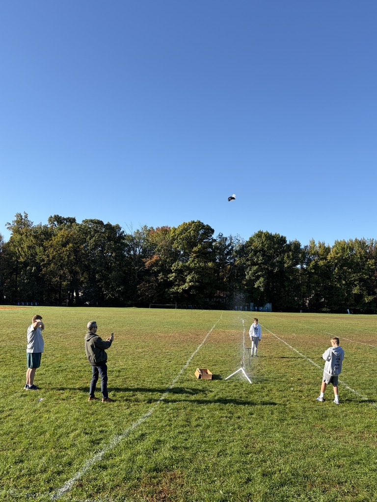 Students launching their rockets while Mr. Wiley records the air time.