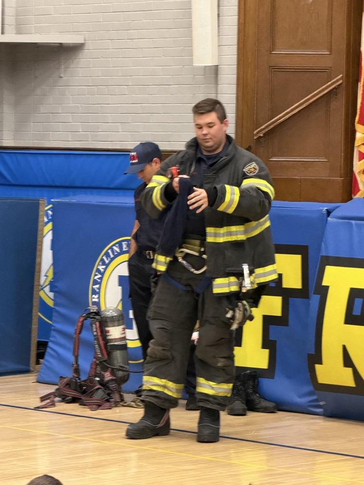 fire fighters talking to students in the gym 
