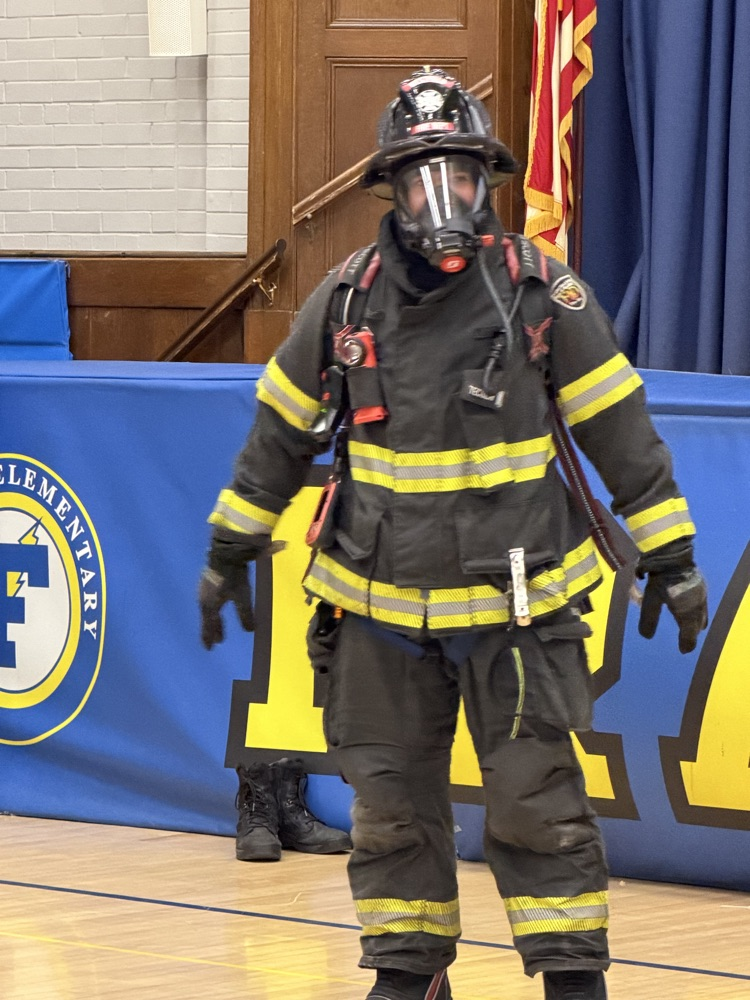 fire fighters talking to students in the gym 