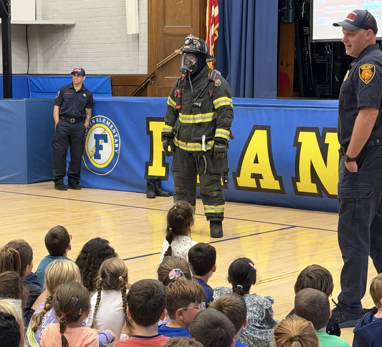 fire fighters talking to students in the gym 