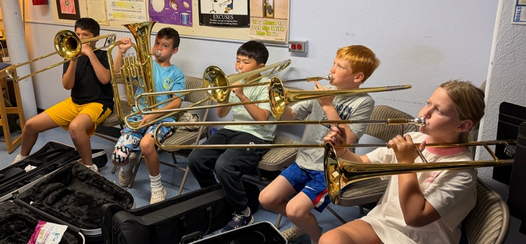 brass players playing their instruments