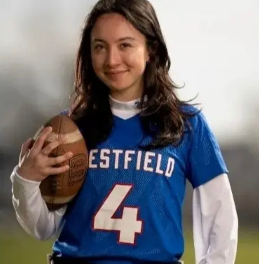 Student holding football.