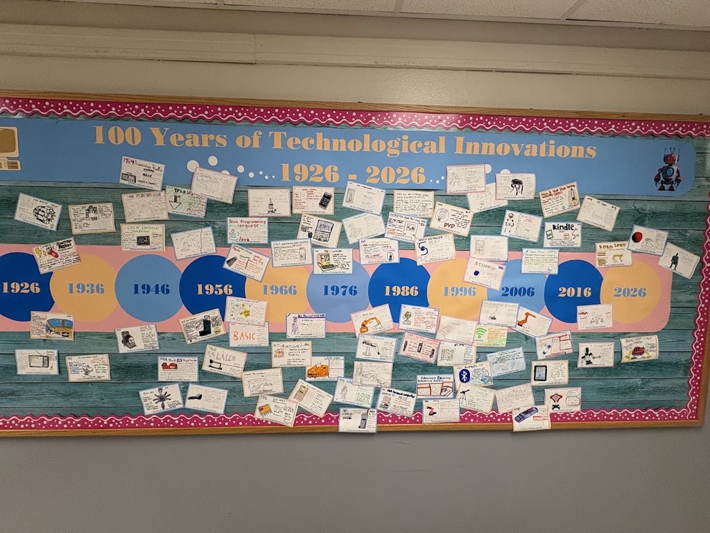 A bulletin board titled 100 Years of Technological Innovations 1926-2026 features a timeline with student drawings of inventions ranging from early radios to modern devices.