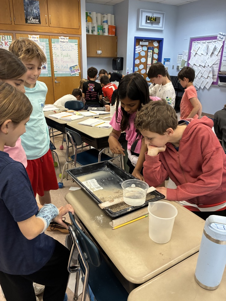 students working in groups on an erosion project 