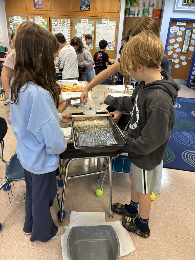 students working in groups on an erosion project 