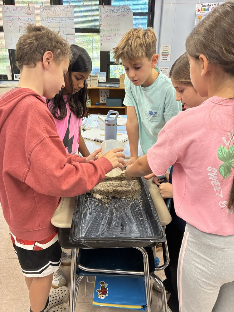 students working in groups on an erosion project 
