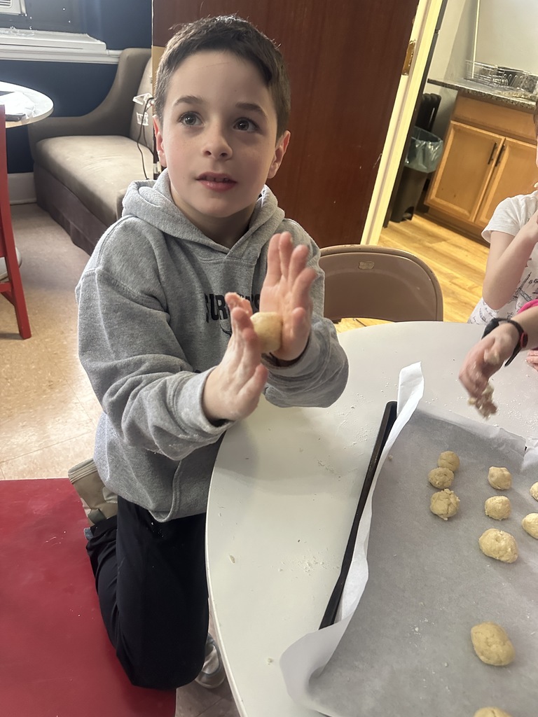 a student forming cookie dough balls