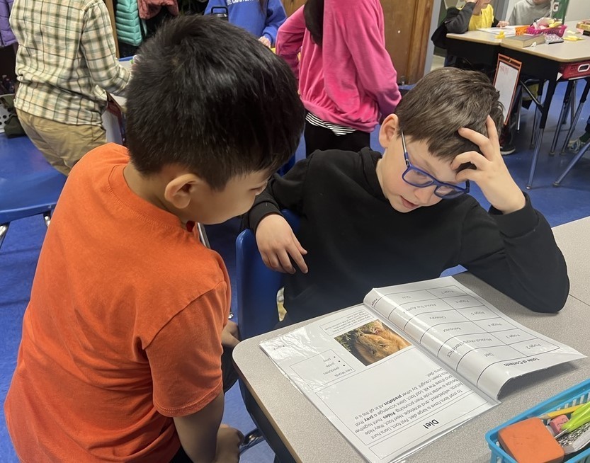 Jefferson 3rd grader reads non-fiction magazine to 2nd grader