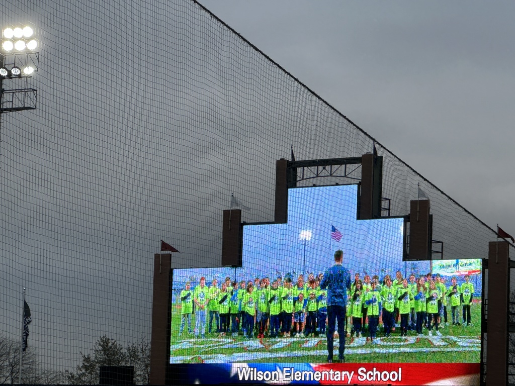 Wilson fifth grade singers on the stadium's screen