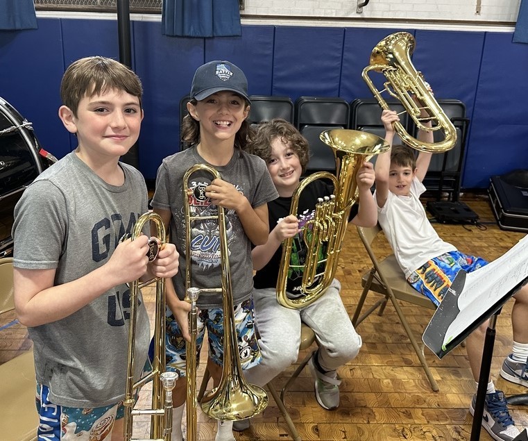 Members of Wilson Grade 4 Band pose for a picture, holding their instruments